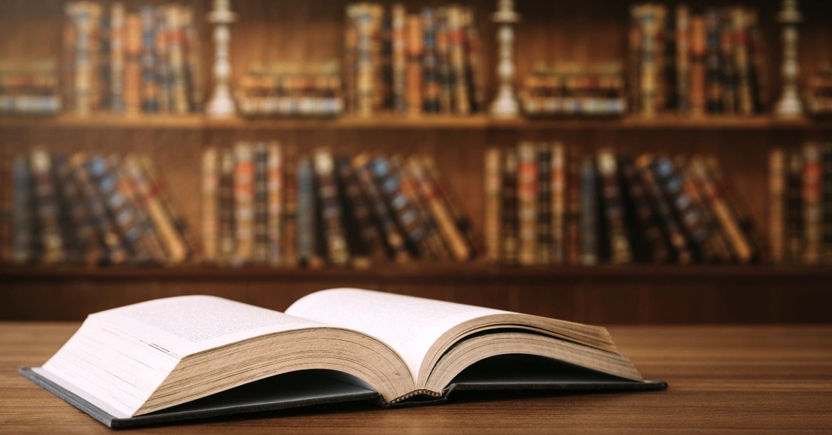 Antique wooden desk with genealogy documents, letters, and a vintage inkwell